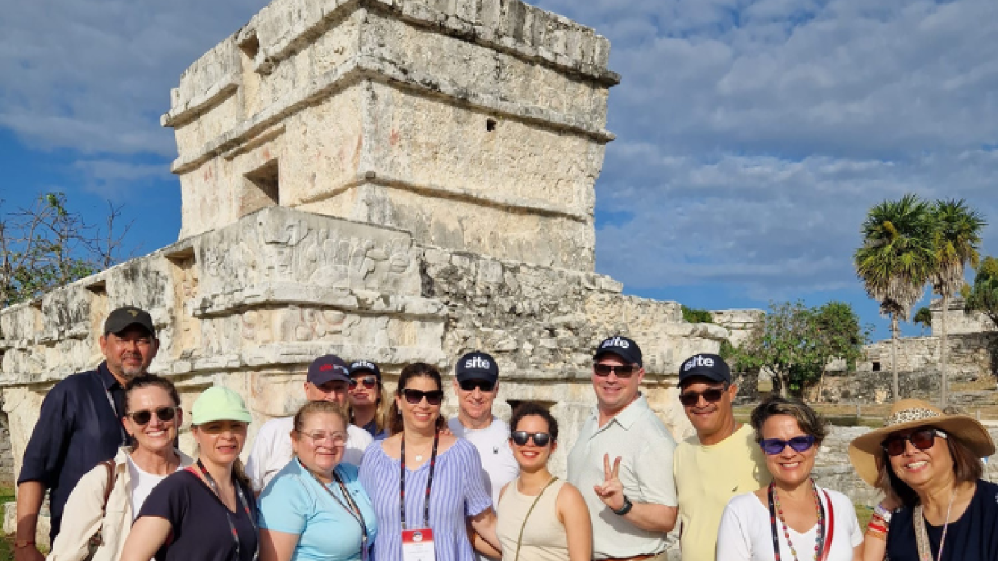 group posed in front of ruins